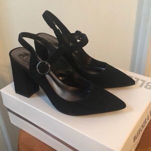 Black pointy heels with silver buckle